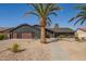 Charming home showcasing desert landscaping, wooden garage door, and concrete stepping stones at 5726 E Woodridge Dr, Scottsdale, AZ 85254