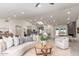 Bright living room with vaulted ceilings, skylight, a fireplace and views into the modern kitchen at 5726 E Woodridge Dr, Scottsdale, AZ 85254