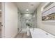 A soaking tub and walk in shower are focal points in this primary bathroom at 5726 E Woodridge Dr, Scottsdale, AZ 85254