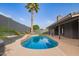 Relaxing pool area with lush green trees, a towering palm, and a backyard design perfect for summer at 5726 E Woodridge Dr, Scottsdale, AZ 85254