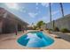 The glistening pool is the focal point of this yard, surrounded by easy-care desert landscaping at 5726 E Woodridge Dr, Scottsdale, AZ 85254