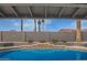 A close up under the patio, featuring a beautiful pool with clear blue water and a surrounding landscaped patio at 5726 E Woodridge Dr, Scottsdale, AZ 85254