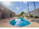 Backyard oasis with a refreshing pool, patio, and view of the well-maintained exterior of the home at 5726 E Woodridge Dr, Scottsdale, AZ 85254