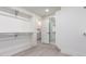 Large walk-in closet featuring hanging racks, shelving and light wood-look floors at 5726 E Woodridge Dr, Scottsdale, AZ 85254