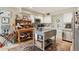 Bright kitchen featuring white cabinetry, stainless steel appliances, an island, and mosaic backsplash at 5825 N 12Th St # 3, Phoenix, AZ 85014