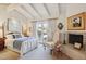 Serene bedroom features a king bed, fireplace, and French doors leading to a private balcony at 5825 N 12Th St # 3, Phoenix, AZ 85014