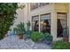 This cozy patio features stone flooring, potted plants, and large windows to bring in natural light at 5825 N 12Th St # 3, Phoenix, AZ 85014