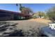 Exterior view showing covered parking, desert landscaping and paved driveway at 6528 N Hillside Dr, Paradise Valley, AZ 85253