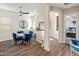 Bright dining area with wood floors, modern ceiling fan, and a stylish table set with blue chairs at 70 E Kennedia Dr, Queen Creek, AZ 85140