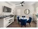 Stylish dining area with a bar, mini-fridge, and sleek table and chairs at 70 E Kennedia Dr, Queen Creek, AZ 85140