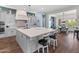 Open kitchen with grey cabinetry, a large island, tile backsplash, and stainless steel appliances at 70 E Kennedia Dr, Queen Creek, AZ 85140