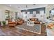 Spacious living room featuring tan leather furniture, a black and white rug, and modern decor at 70 E Kennedia Dr, Queen Creek, AZ 85140