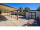 Covered patio, with spacious backyard featuring desert landscaping, storage shed, and an outdoor seating area at 7335 W Mission Ln, Peoria, AZ 85345