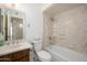 Bright bathroom featuring a granite sink, large mirror, toilet, and bath tub with shower at 7335 W Mission Ln, Peoria, AZ 85345