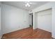 Clean, carpetless bedroom featuring a ceiling fan, closet, and white walls at 7335 W Mission Ln, Peoria, AZ 85345