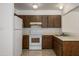 Traditional kitchen with white appliances, wood cabinets, and ample countertop space at 7335 W Mission Ln, Peoria, AZ 85345