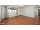 Bright living room featuring wood floors, a large window, and a white front door at 7335 W Mission Ln, Peoria, AZ 85345