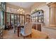 Inviting dining room with a large window, elegant chandelier, and decorative built-in cabinet at 7705 E Doubletree Ranch Rd # 29, Scottsdale, AZ 85258