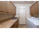 Well-equipped laundry room with ample cabinetry, counter space, sink, and modern washer/dryer at 7705 E Doubletree Ranch Rd # 29, Scottsdale, AZ 85258