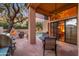 Inviting covered patio with stone flooring, outdoor kitchen, fireplace, and views of the sparkling pool at 7705 E Doubletree Ranch Rd # 29, Scottsdale, AZ 85258