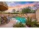 Beautiful pool area featuring mature trees, a baja step, desert landscape, and a cozy fireplace at 7705 E Doubletree Ranch Rd # 29, Scottsdale, AZ 85258