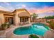 Beautiful backyard pool with a covered patio, outdoor fireplace, and lush desert landscaping at 7705 E Doubletree Ranch Rd # 29, Scottsdale, AZ 85258