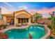 Beautiful backyard pool with a covered patio, outdoor fireplace, and desert landscaping at 7705 E Doubletree Ranch Rd # 29, Scottsdale, AZ 85258