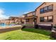 Exterior view of the backyard showcasing the pool, hot tub, and covered patio with stairs at 7910 W Spur Dr, Peoria, AZ 85383