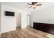 Bedroom with ceiling fan, wood floor, and dark wood dresser at 7910 W Spur Dr, Peoria, AZ 85383