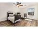 Bright bedroom features two beds, modern ceiling fan, and a window letting in natural light at 7910 W Spur Dr, Peoria, AZ 85383