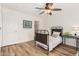 This cozy bedroom includes neutral paint, wood-look flooring, and a ceiling fan for comfort at 7910 W Spur Dr, Peoria, AZ 85383