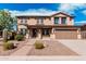 Inviting two-story home featuring a well-manicured yard and attached two-car garage at 7910 W Spur Dr, Peoria, AZ 85383