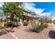 Charming two-story home featuring an attached two-car garage and desert landscaping at 7910 W Spur Dr, Peoria, AZ 85383