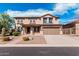 Inviting two-story home featuring a well-manicured yard and attached two-car garage at 7910 W Spur Dr, Peoria, AZ 85383