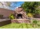 Close up of an outdoor fireplace constructed with brickwork and featuring stacked firewood inside at 7910 W Spur Dr, Peoria, AZ 85383