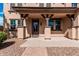 Inviting covered porch with a stylish front door and desert landscaping at 7910 W Spur Dr, Peoria, AZ 85383