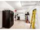 Functional garage space featuring ample storage shelves, lawn care equipment, and secondary refrigerator at 7910 W Spur Dr, Peoria, AZ 85383