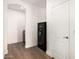 Hallway with a dark safe, white door, and entrance to the powder room at 7910 W Spur Dr, Peoria, AZ 85383