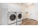 Well-equipped laundry room includes cabinetry, washer, dryer, and door to the exterior at 7910 W Spur Dr, Peoria, AZ 85383