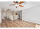 Open loft area with wood-look flooring, a ceiling fan, and lots of natural light at 7910 W Spur Dr, Peoria, AZ 85383