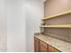 Large pantry with a granite countertop and storage shelves at 7910 W Spur Dr, Peoria, AZ 85383