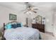 Well-lit bedroom features a ceiling fan, carpet, closet, and a decorative dresser at 8101 N 107Th Ave # 23, Peoria, AZ 85345