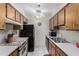 Galley kitchen features stainless steel sink, stove, and plenty of wooden cabinet storage at 8101 N 107Th Ave # 23, Peoria, AZ 85345