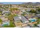 A beautiful bird's-eye shot of a house nestled in a neighborhood with green trees, pool, and mountain views at 829 E Desert Park Ln, Phoenix, AZ 85020