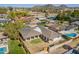 Expansive aerial view of a well-kept home with a backyard pool amidst a lush landscape and a mountain backdrop at 829 E Desert Park Ln, Phoenix, AZ 85020