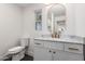 Bathroom vanity with marble top, white cabinets and gold fixtures at 829 E Desert Park Ln, Phoenix, AZ 85020