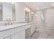 Bathroom with double vanity, marble countertops, and a glass-enclosed shower at 829 E Desert Park Ln, Phoenix, AZ 85020