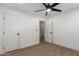 Bedroom with hardwood floors, ceiling fan, two white doors and fresh paint at 829 E Desert Park Ln, Phoenix, AZ 85020