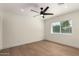 Bright bedroom features hardwood floors, fan, and a window with blinds at 829 E Desert Park Ln, Phoenix, AZ 85020