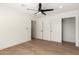 Bedroom with hardwood floors, ceiling fan, closet and fresh paint at 829 E Desert Park Ln, Phoenix, AZ 85020